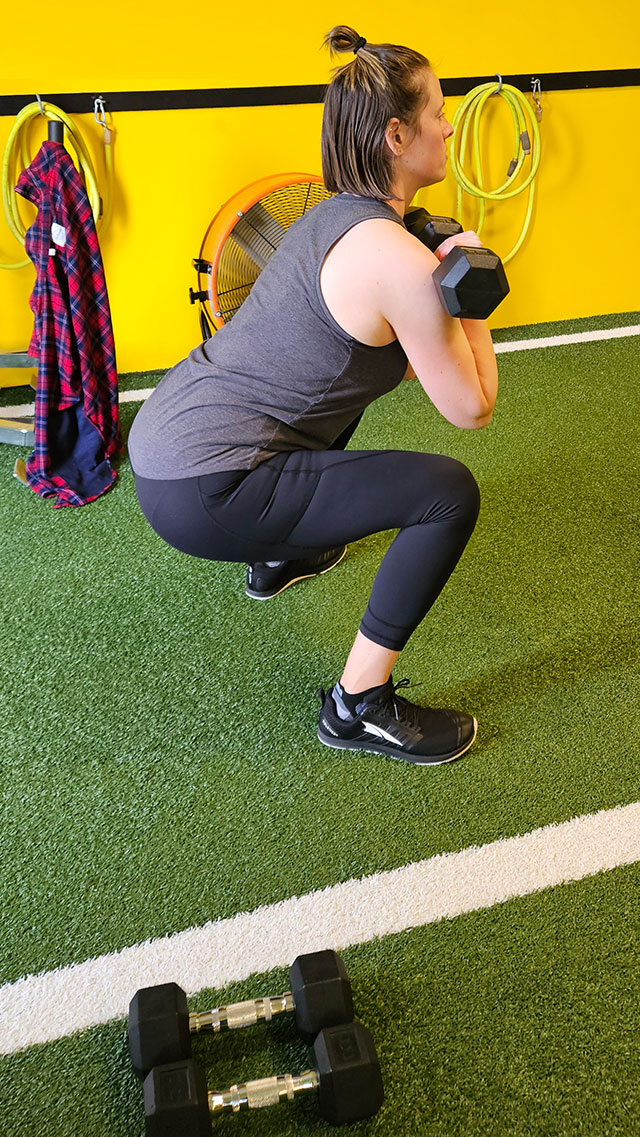 person squatting in exercise